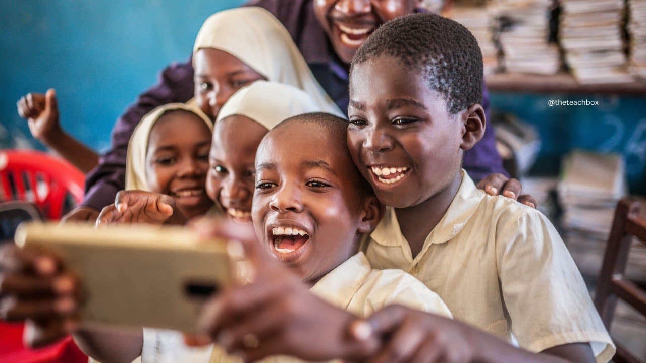 Children exploring a digital learning device together